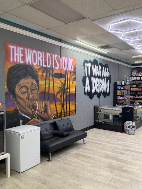 Interior of a store with graffiti art, couch, and displays of merchandise.