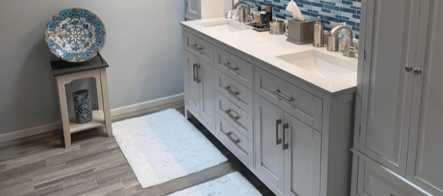 white sink with white small carpets