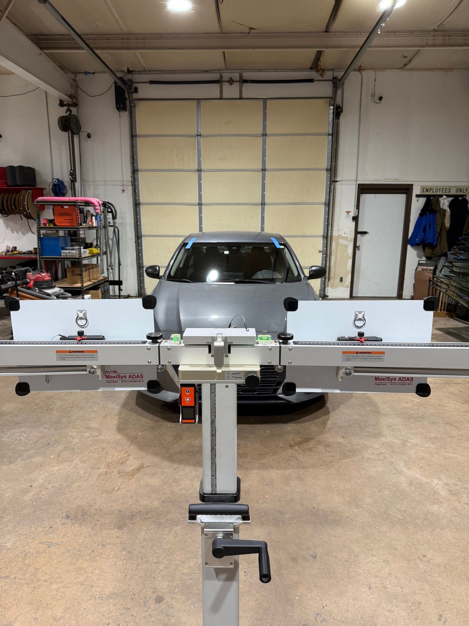 Router table in a garage with a car behind it.