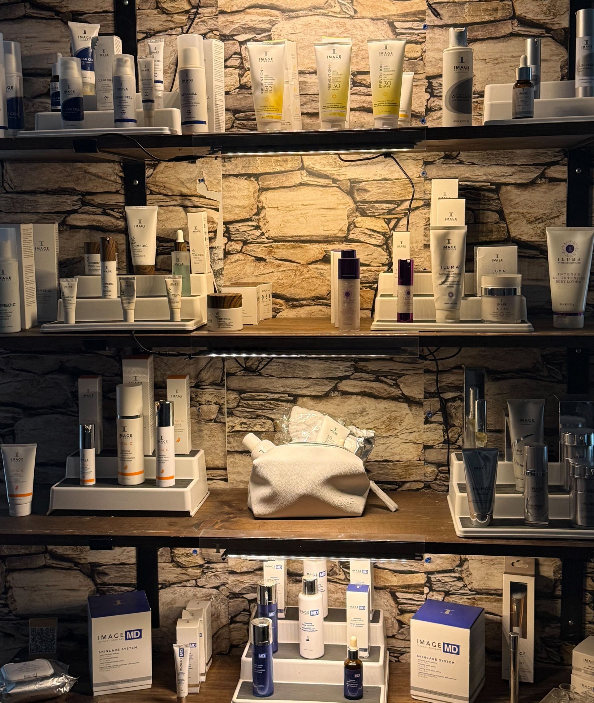 Shelves displaying various skincare products against a brick wall backdrop.