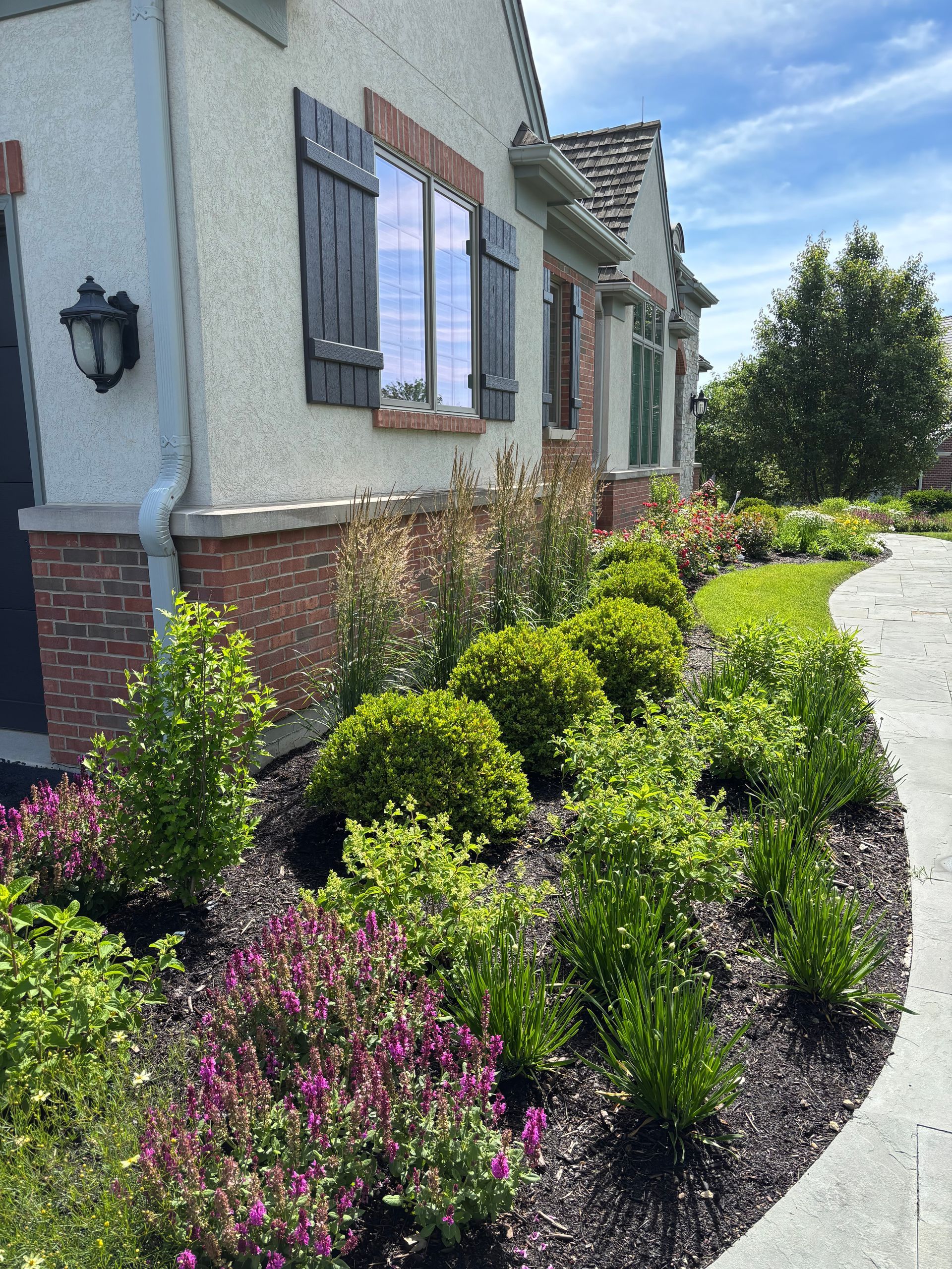 A freshly landscaped flower bed in front of building