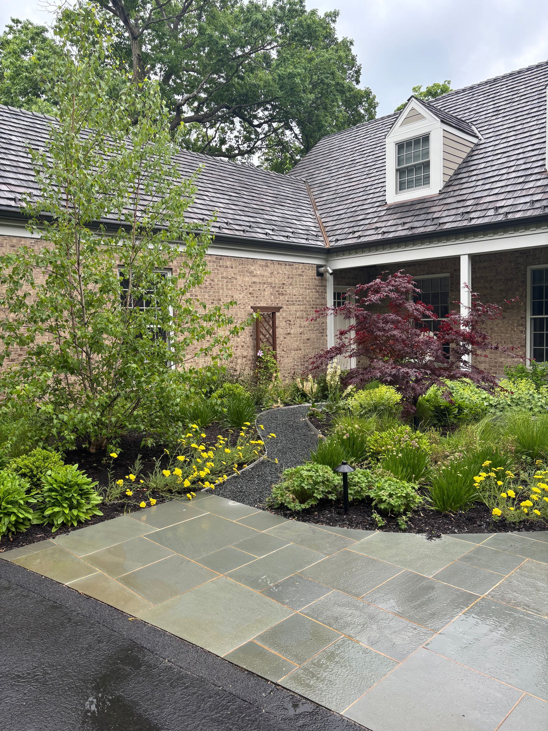 Lush flower beds in front of a house