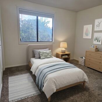 A minimalist, neutral-toned bedroom with a twin bed, a wooden nightstand with a lamp, a dresser, and wall art.