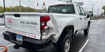 A white truck with a damaged back before.