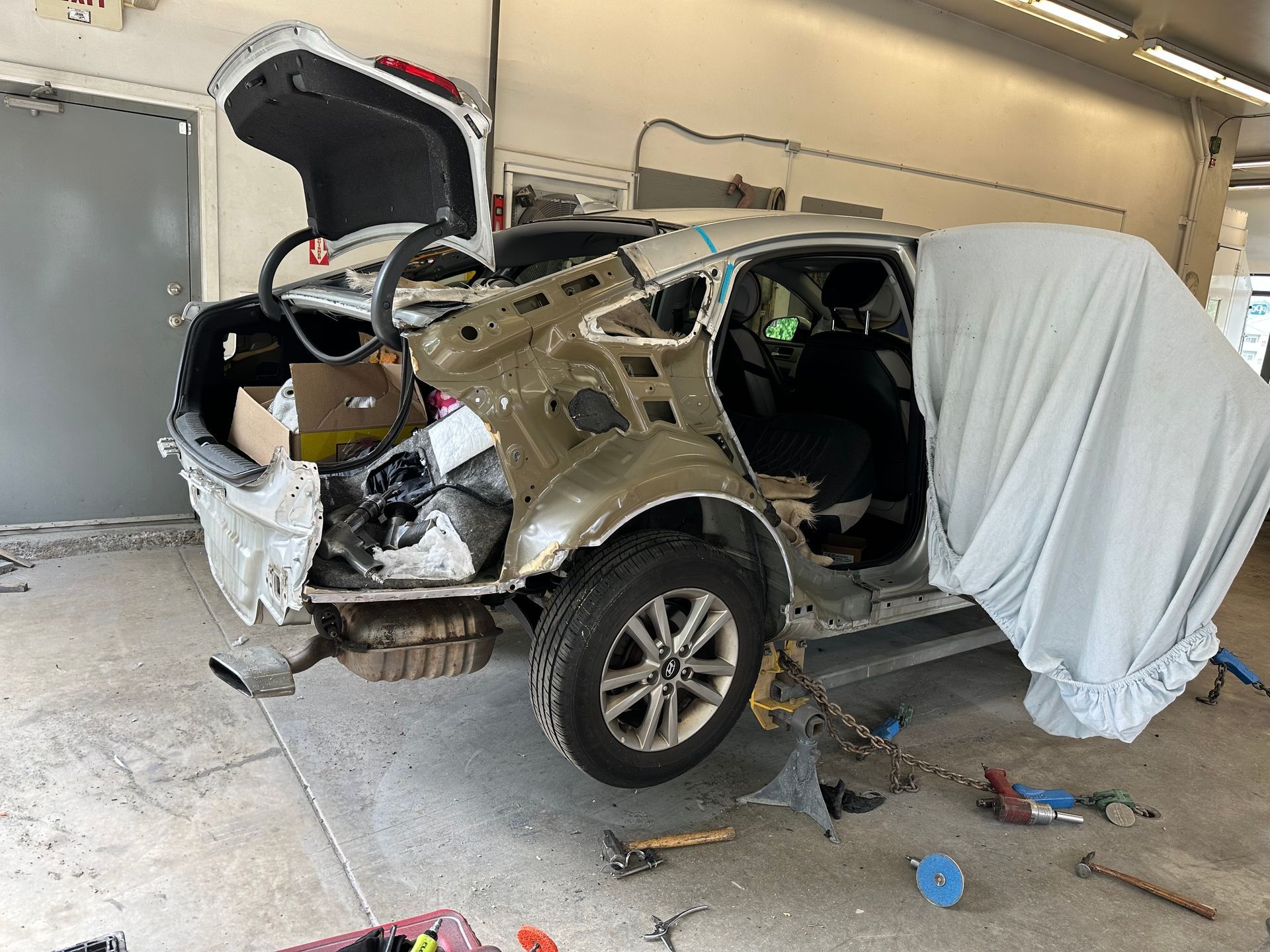 A car is being repaired in a garage before.