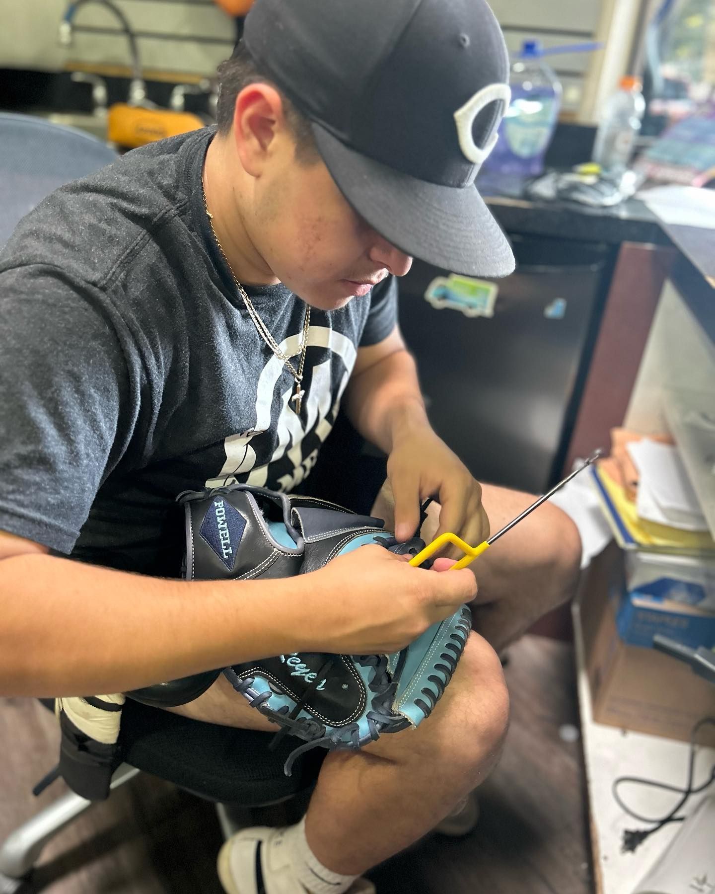 A man wearing a hat with the letter c on it