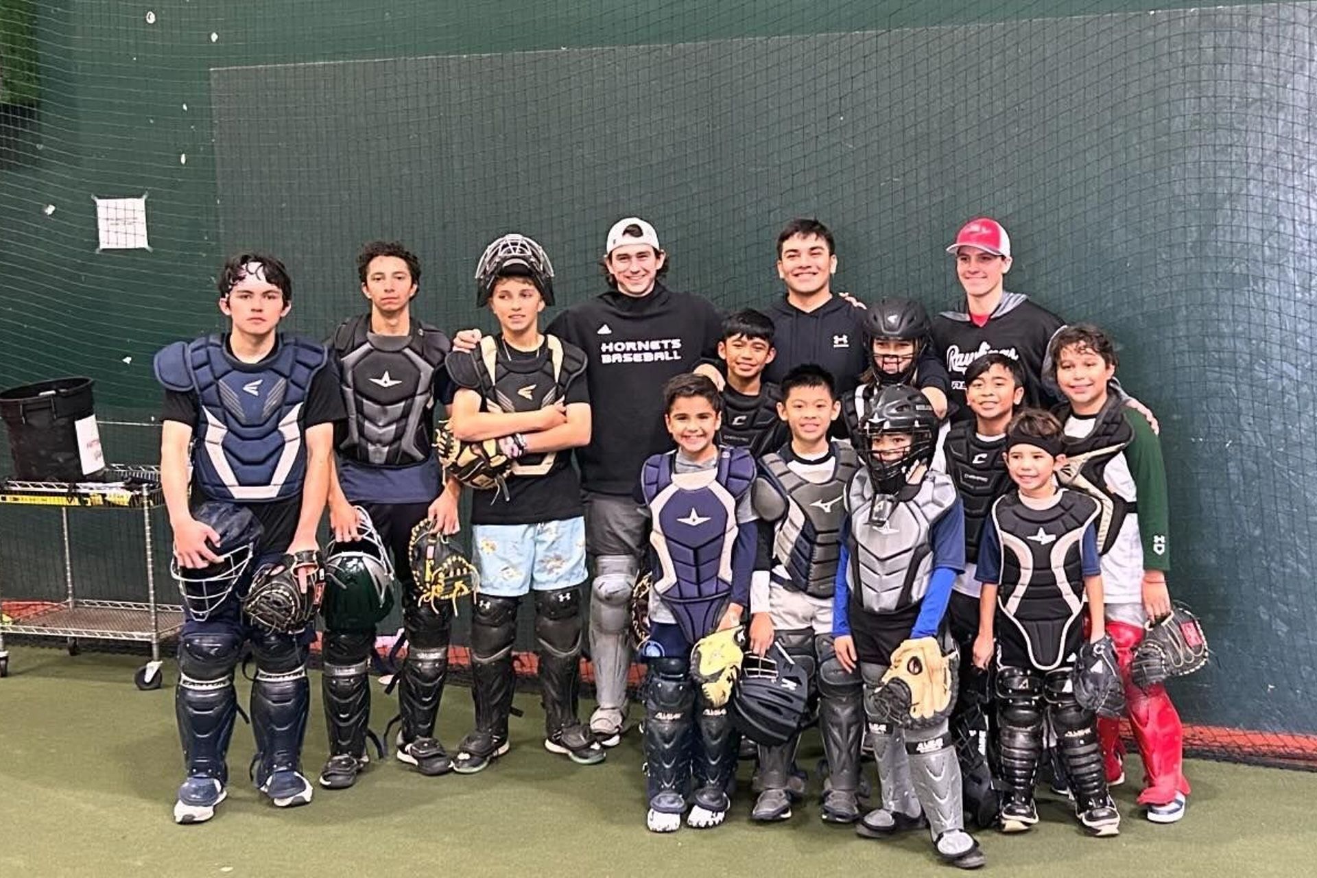 A group of young baseball players are posing for a picture.