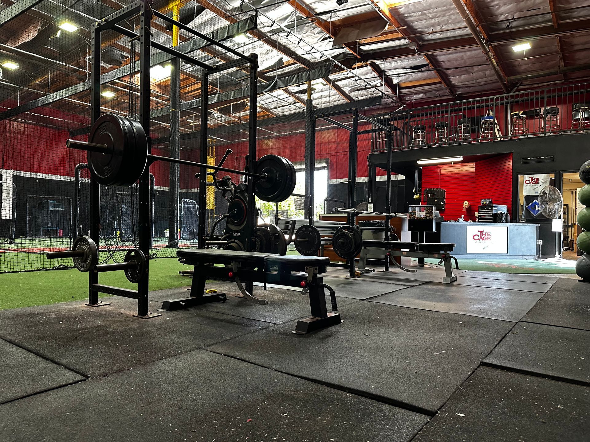 A gym filled with lots of exercise equipment and a bench.