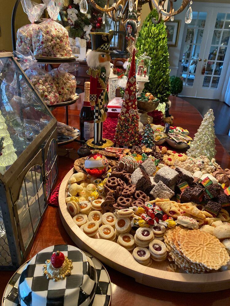 A table topped with a variety of christmas cookies and desserts.
