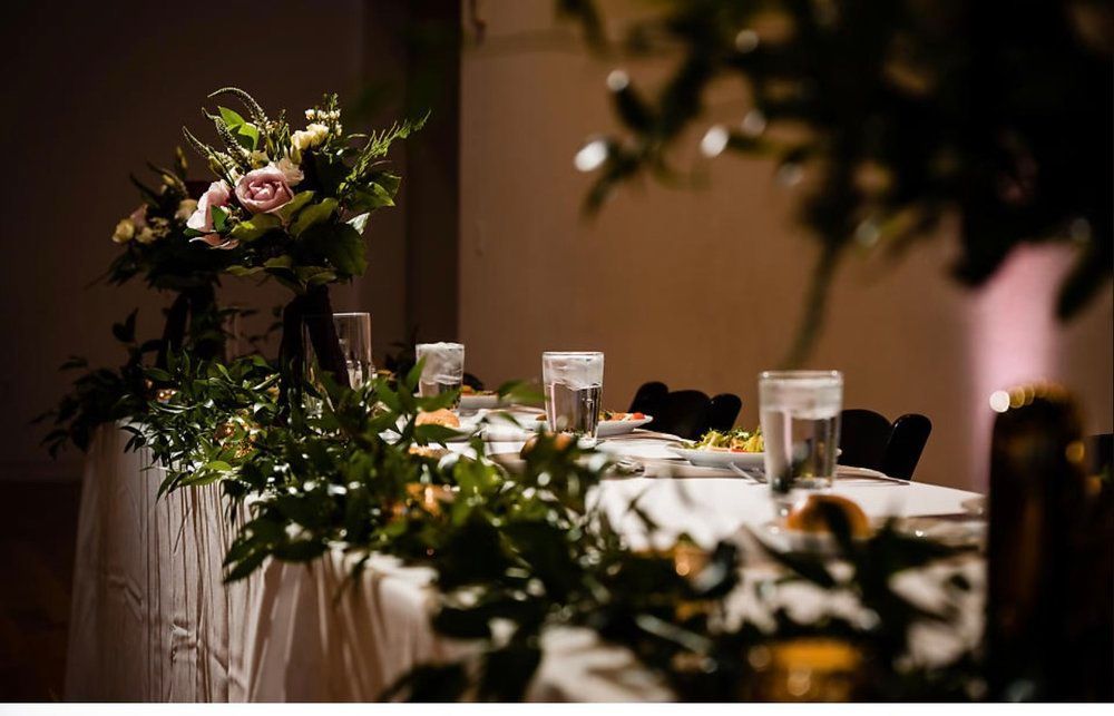 A long table with a vase of flowers on top of it.