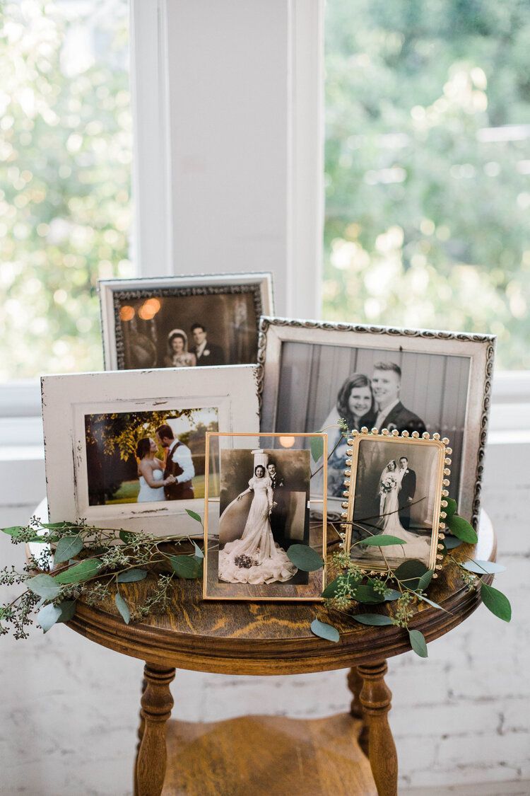 A table topped with a bunch of pictures of a bride and groom.