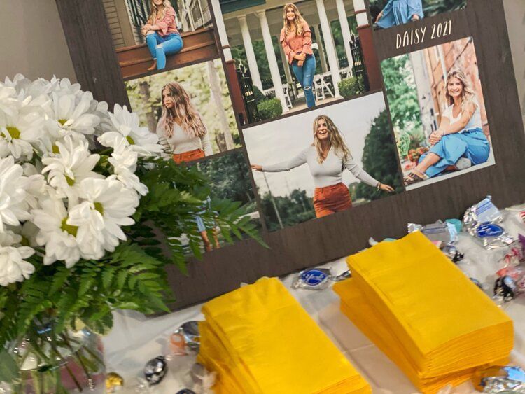 A collage of pictures of a woman is sitting on a table next to a vase of flowers.