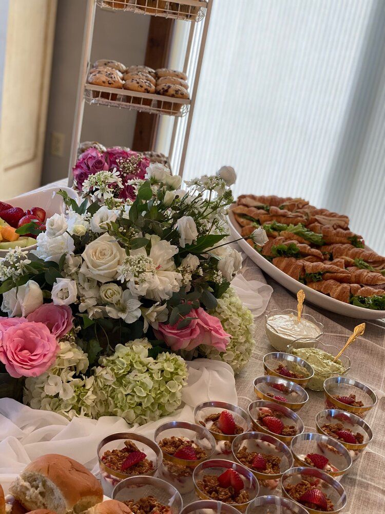 A table topped with a variety of food and flowers.