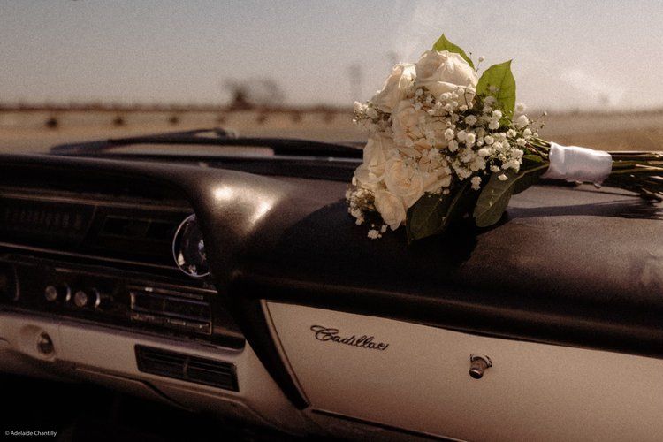 A bouquet of flowers is sitting on the dashboard of a car.