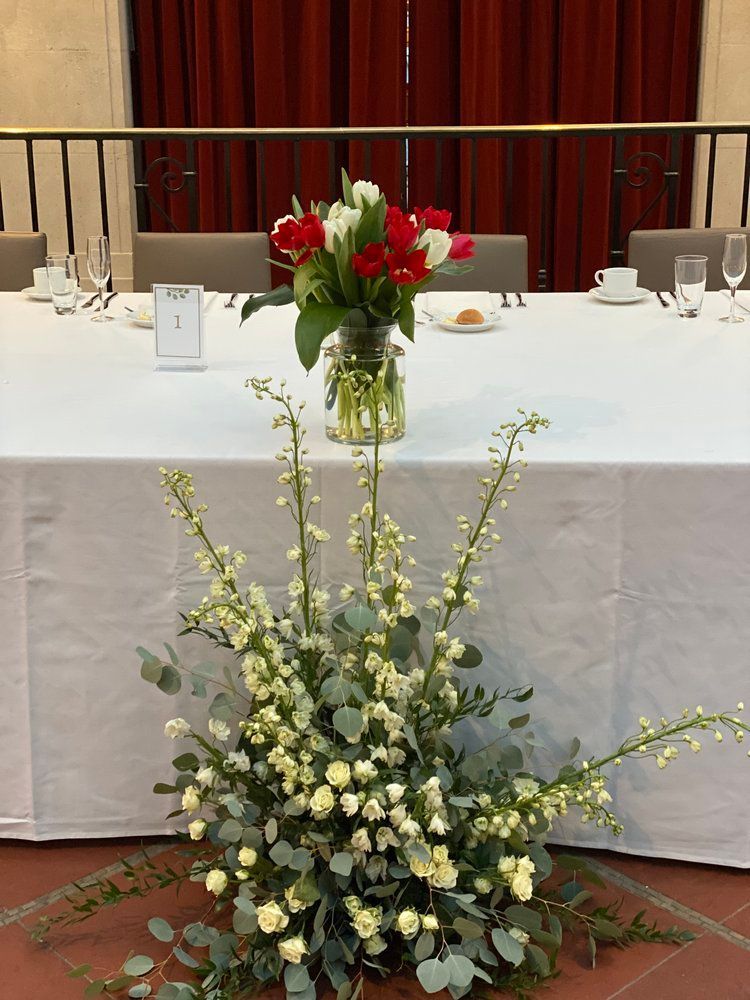 A table with a vase of flowers on it
