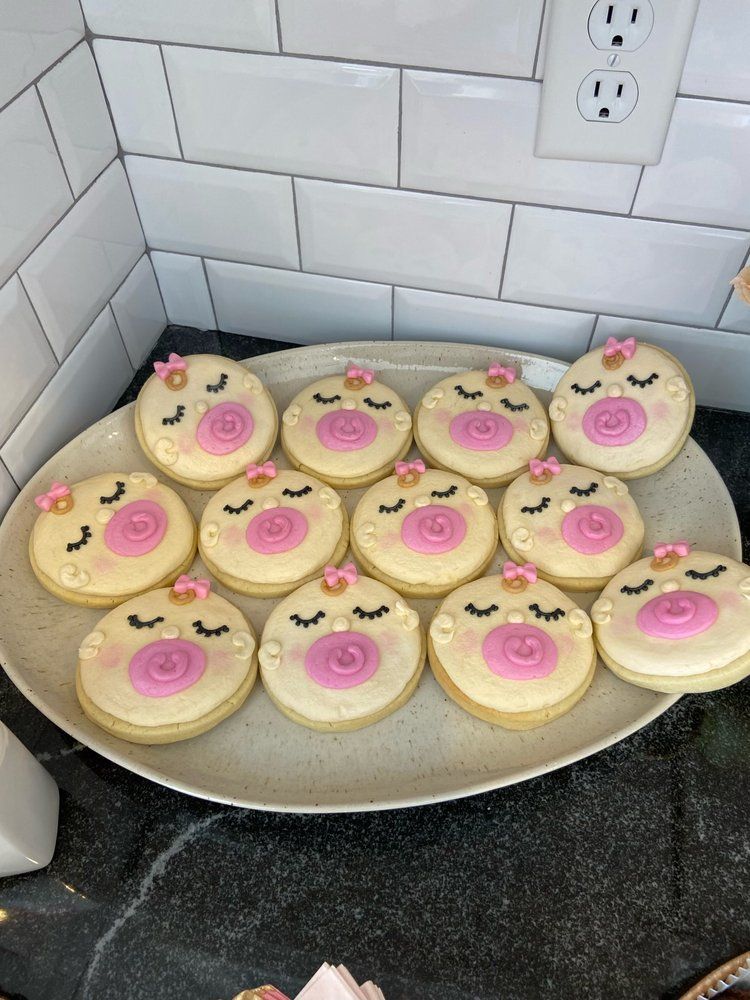 A plate of cookies with a baby face on them
