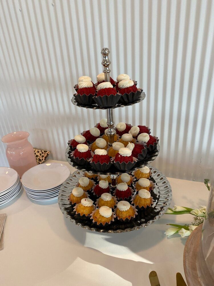 A cupcake tower filled with cupcakes on a table.