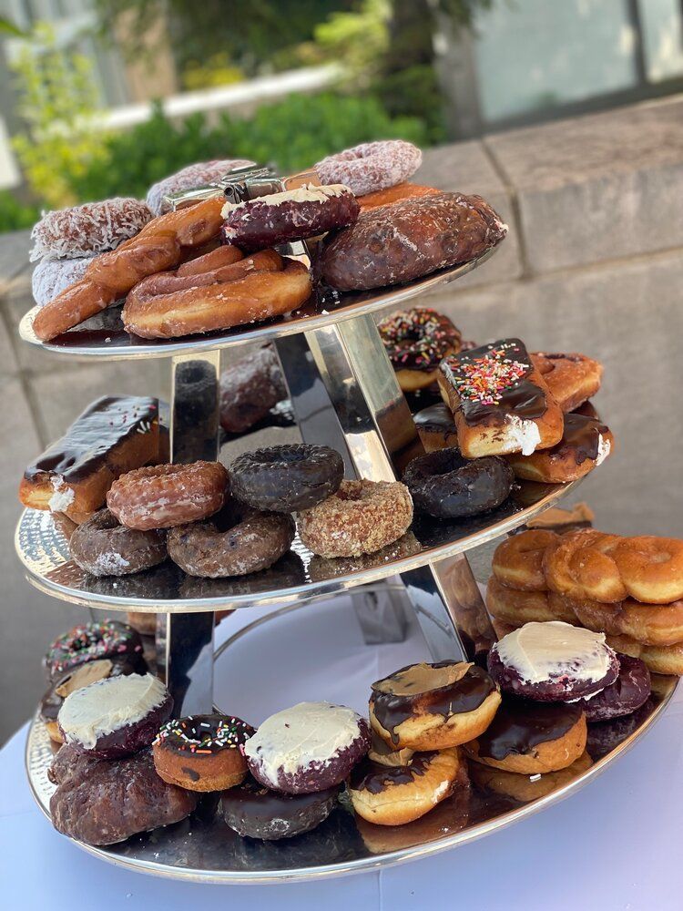 A tower of donuts sitting on top of a table.