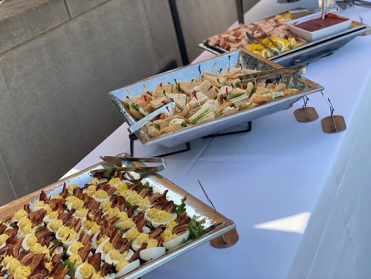 A buffet table with a variety of food on it.
