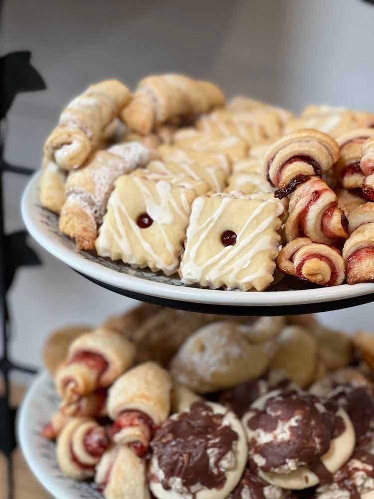 Three plates of cookies are stacked on top of each other on a table.