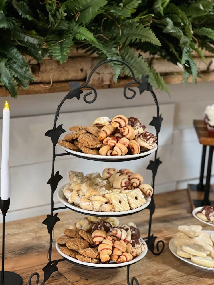 There are many different types of cookies on the plates on the table.