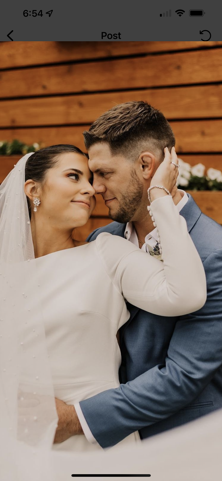 A bride and groom are posing for a picture on their wedding day.