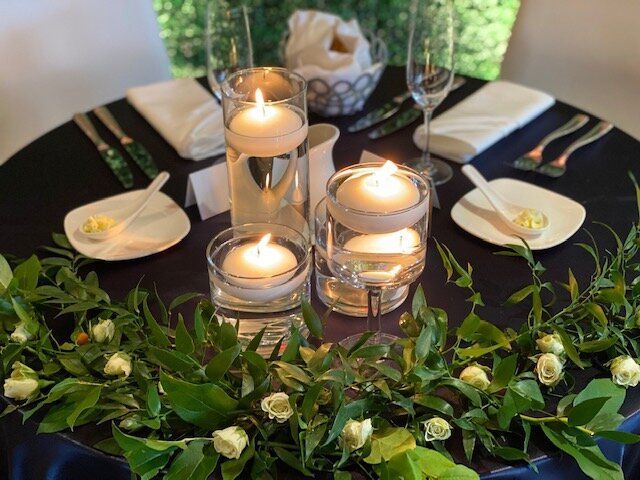 A table with candles and flowers on it