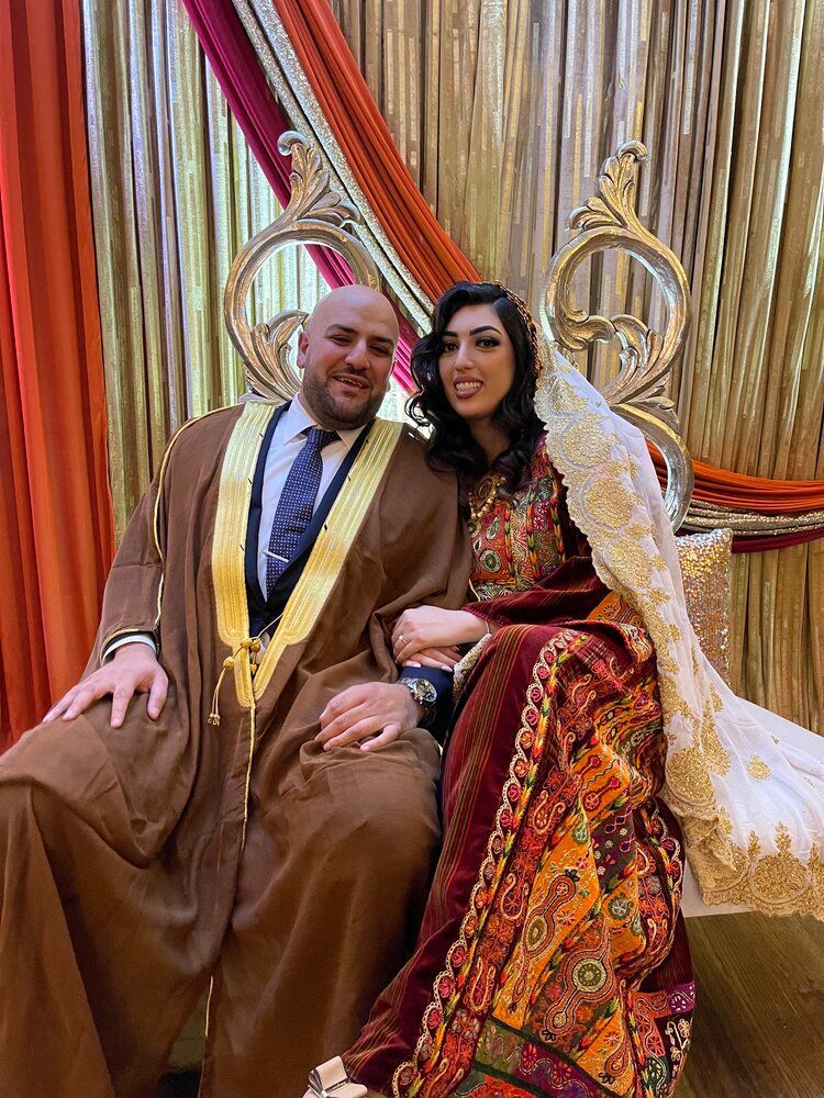 A man and a woman are sitting next to each other on a chair.