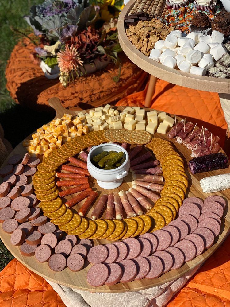 A wooden cutting board filled with lots of different types of food.