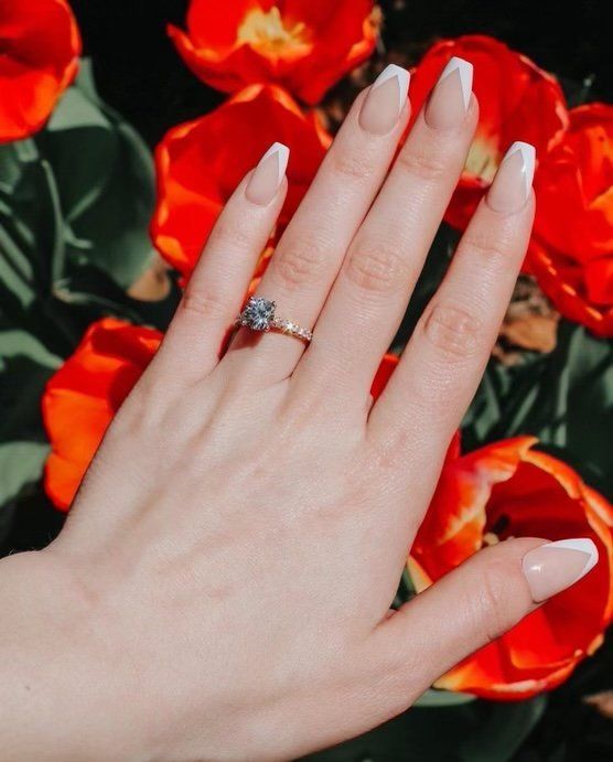A close up of a woman 's hand with a ring on it