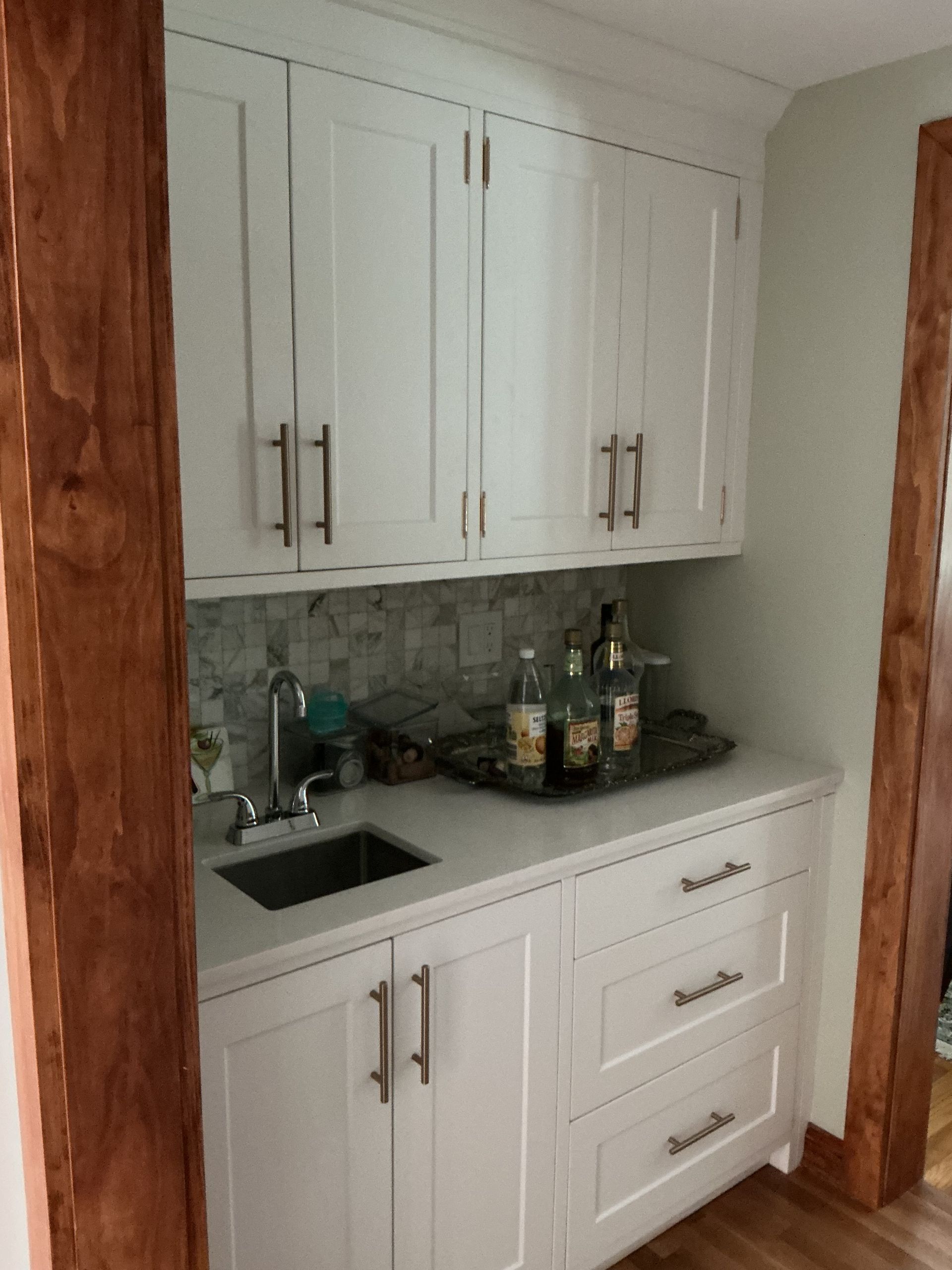 Small white kitchen cabinet with sink, countertop, and upper and lower storage drawers