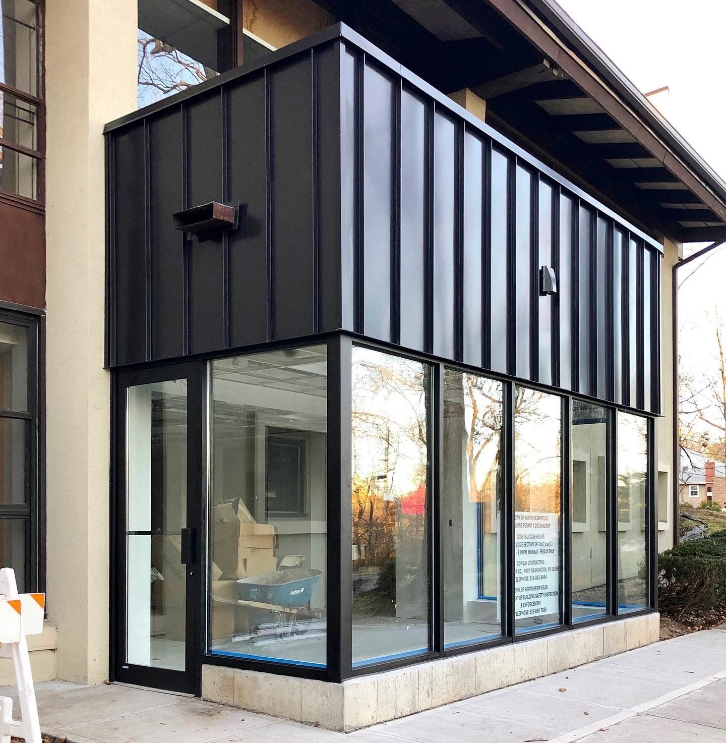 Black metal and glass building extension. Exterior view, contemporary architecture.