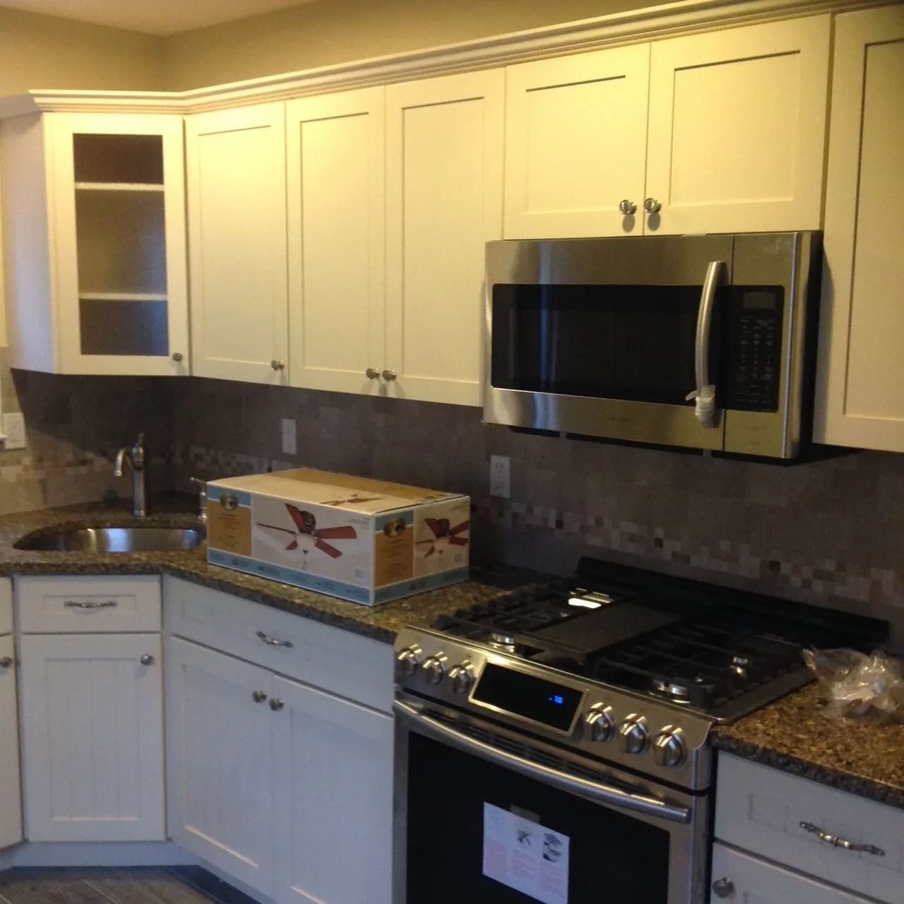 Kitchen with white cabinets, stainless steel appliances, and granite countertops.