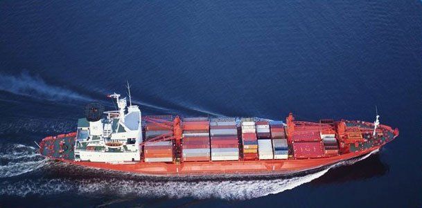 A large container ship is floating on top of a body of water.