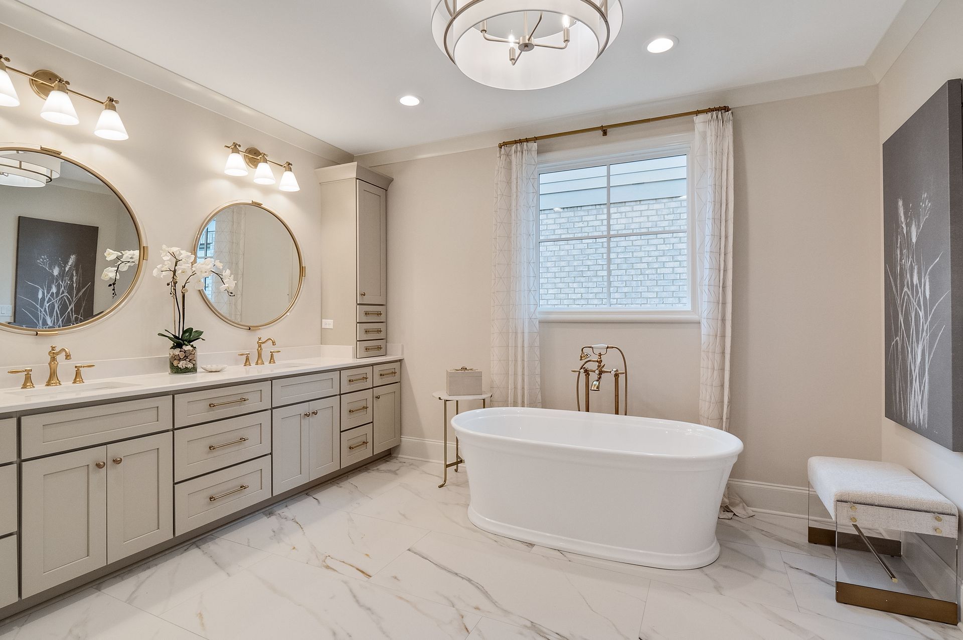 A bathroom with a tub , sinks , mirrors and a window.