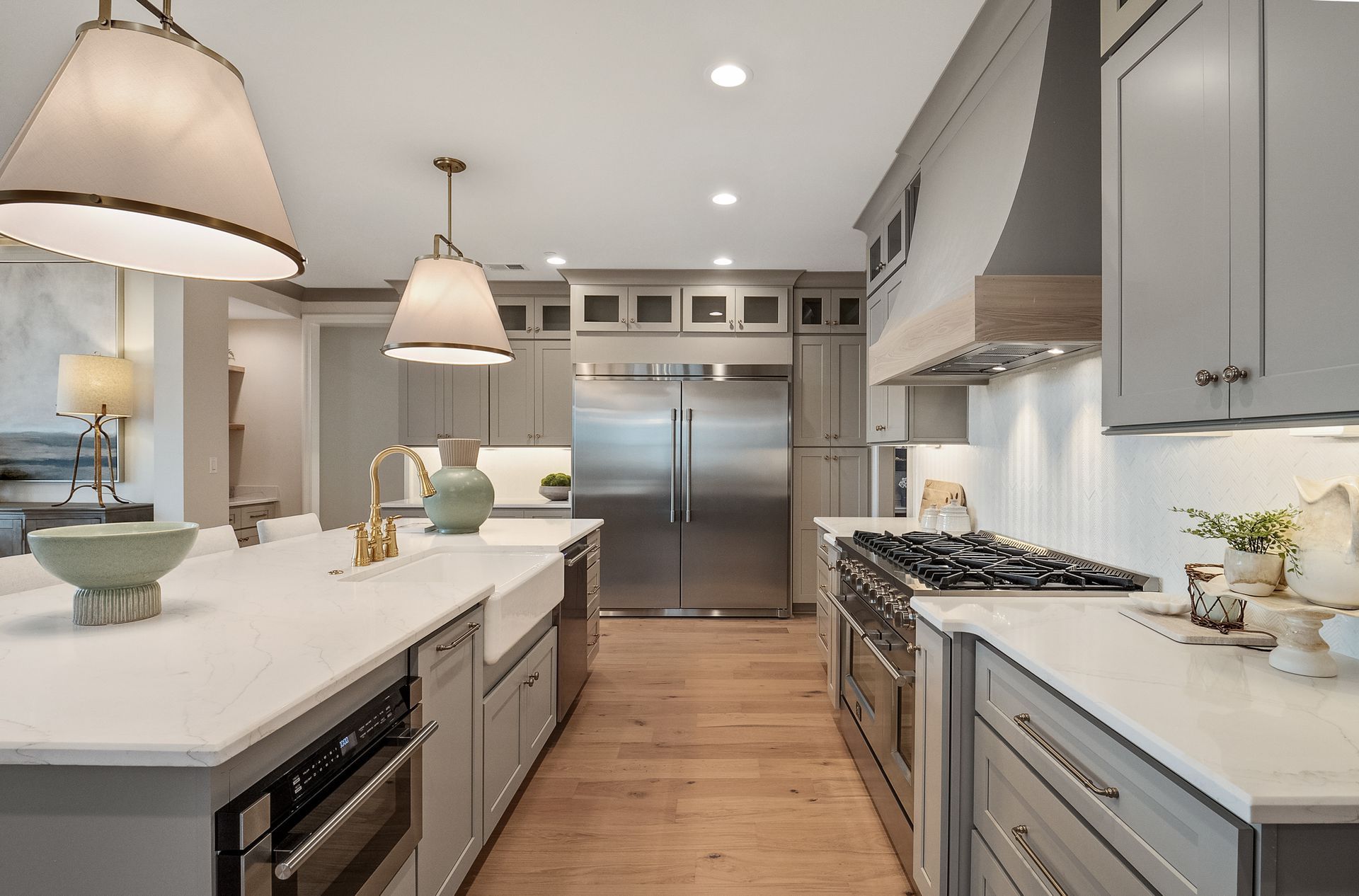 A kitchen with stainless steel appliances and gray cabinets