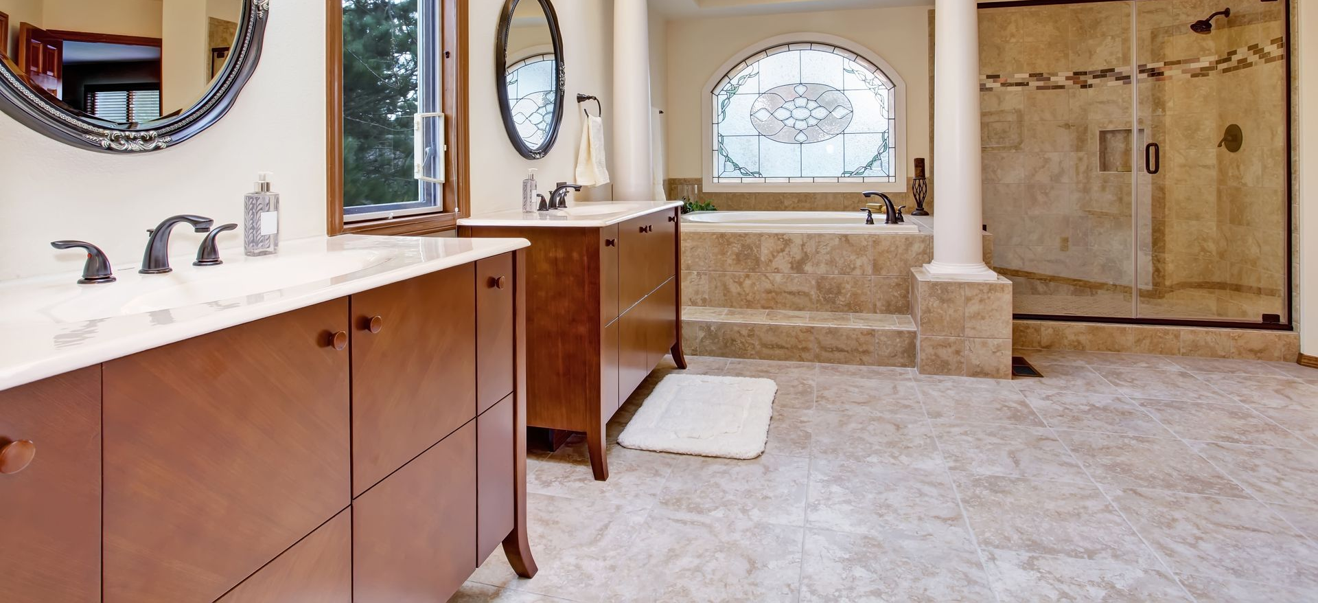 Bright kitchen with wood cabinets, granite counters, stainless steel fridge, and a central island.