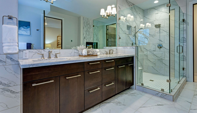 Modern bathroom with marble shower, dark wood vanity, and large mirror