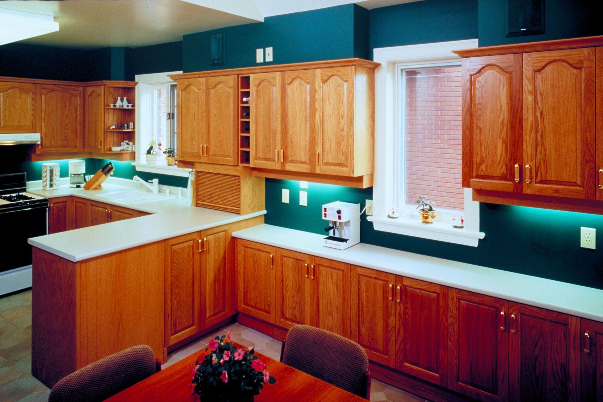 Unfinished kitchen with dark wood cabinets, white walls, and boxes on the floor and counters