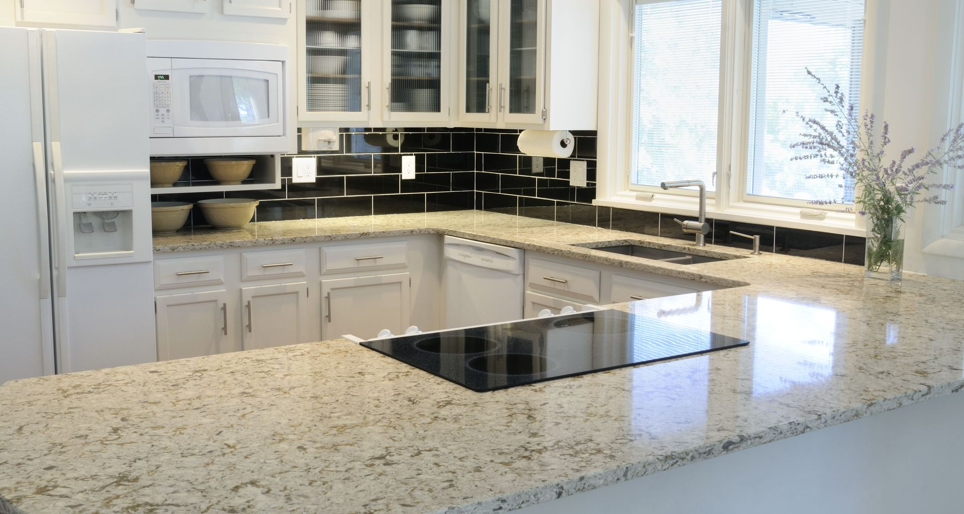 Unfinished kitchen with dark wood cabinets, white walls, and boxes on the floor and counters