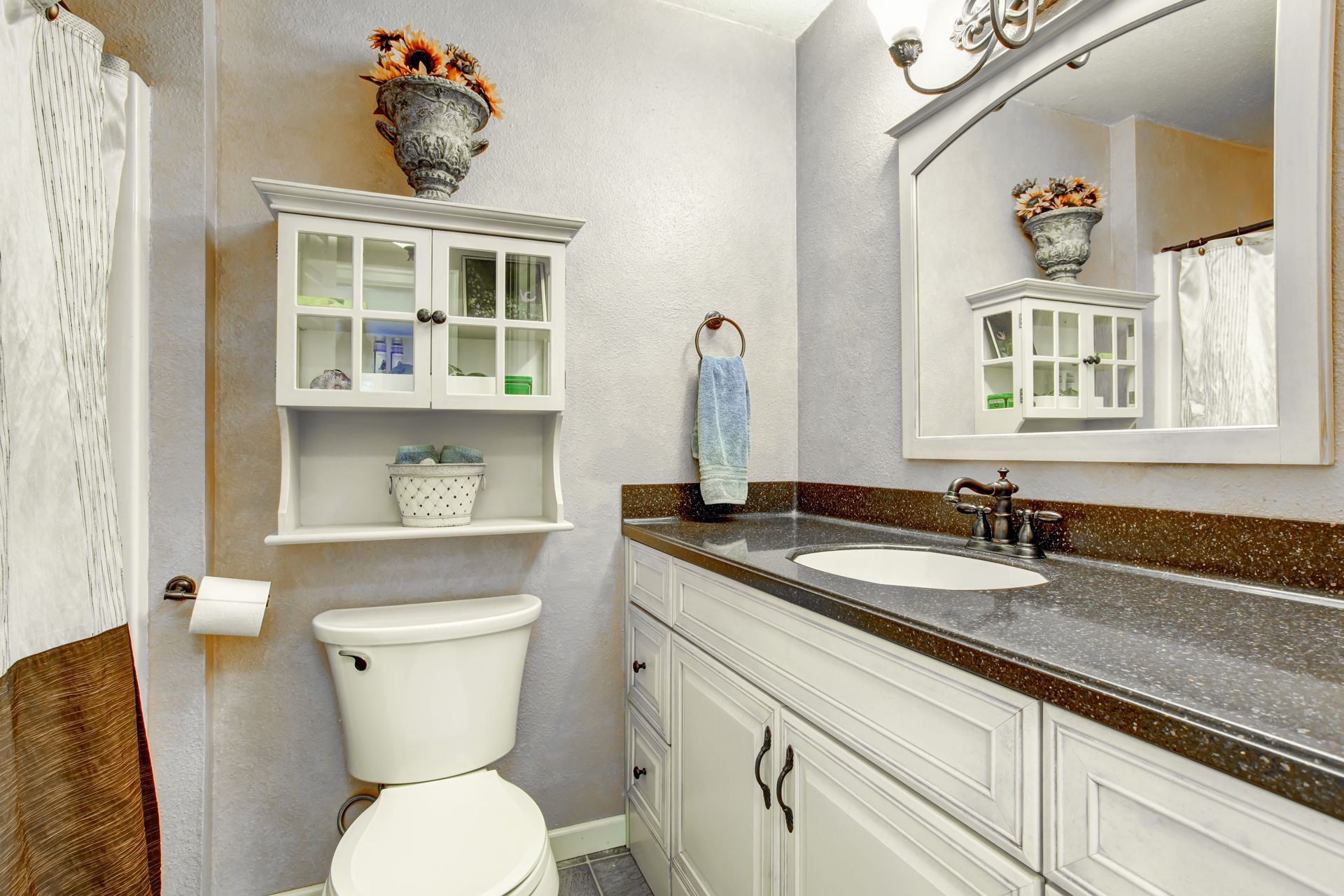 Modern kitchen with white cabinets, stainless appliances, pink mosaic backsplash, and tiled floor
