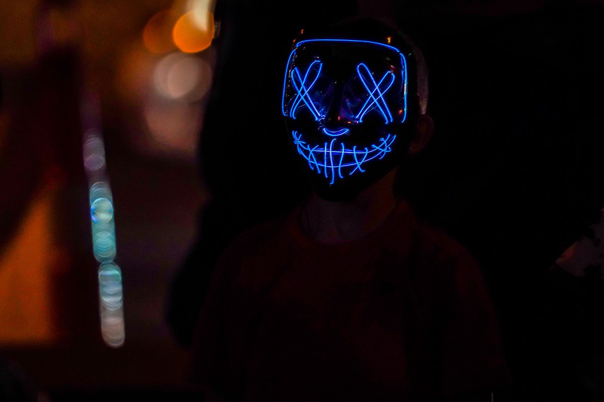 a person wearing a light up mask in the dark