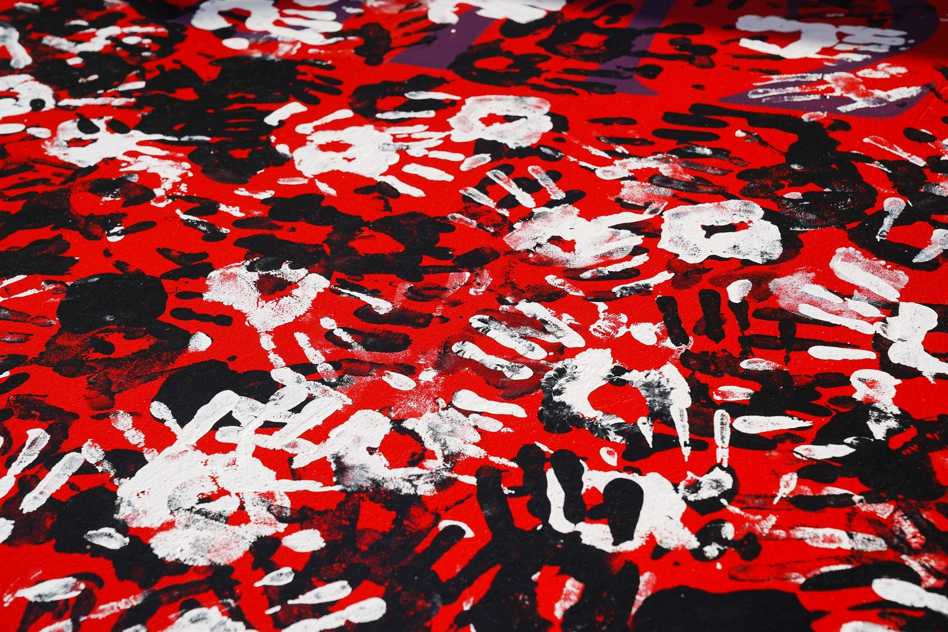 a red and black camouflage pattern with white spots