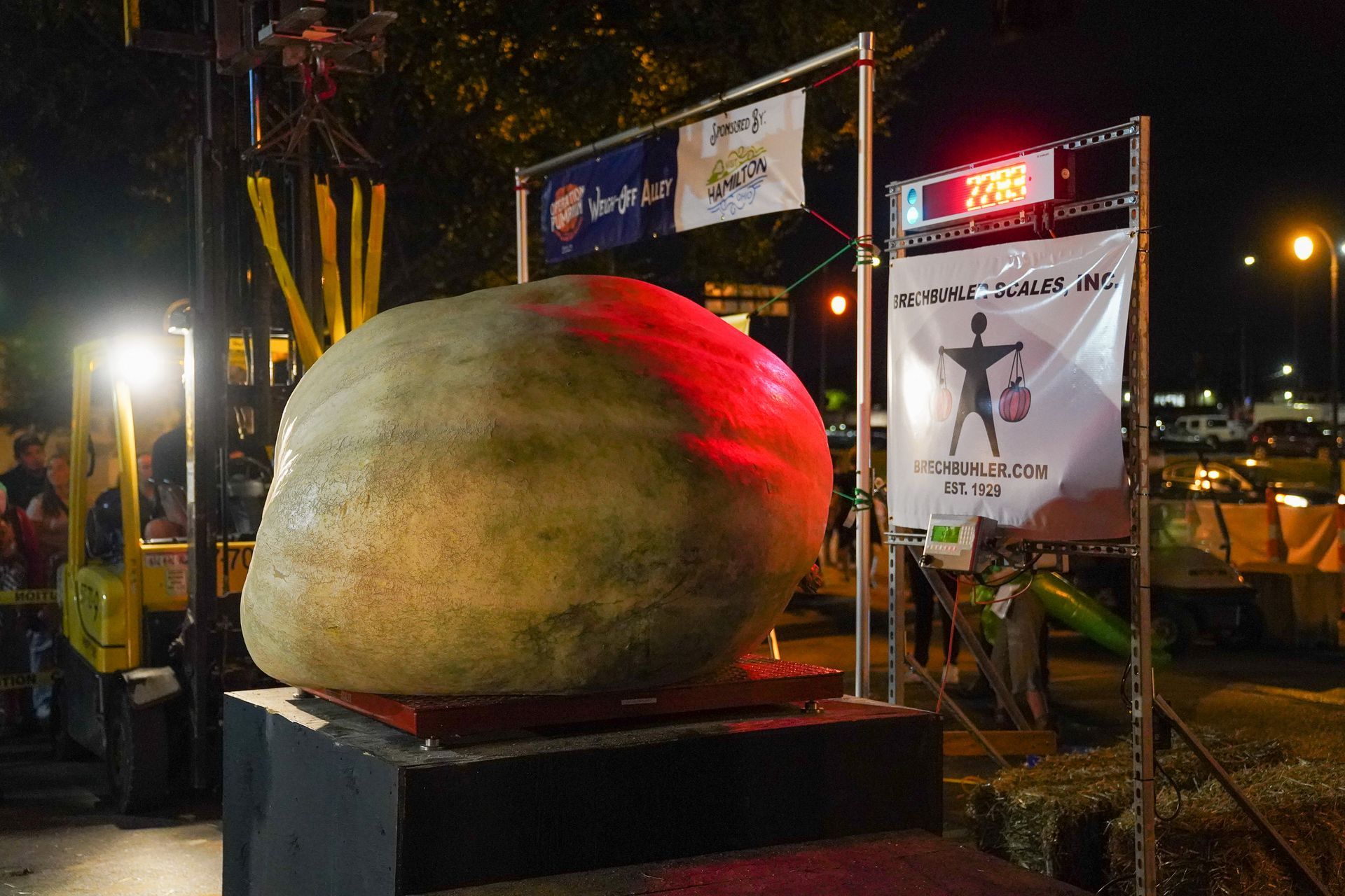 a large pumpkin with a sign that says' peach' on it