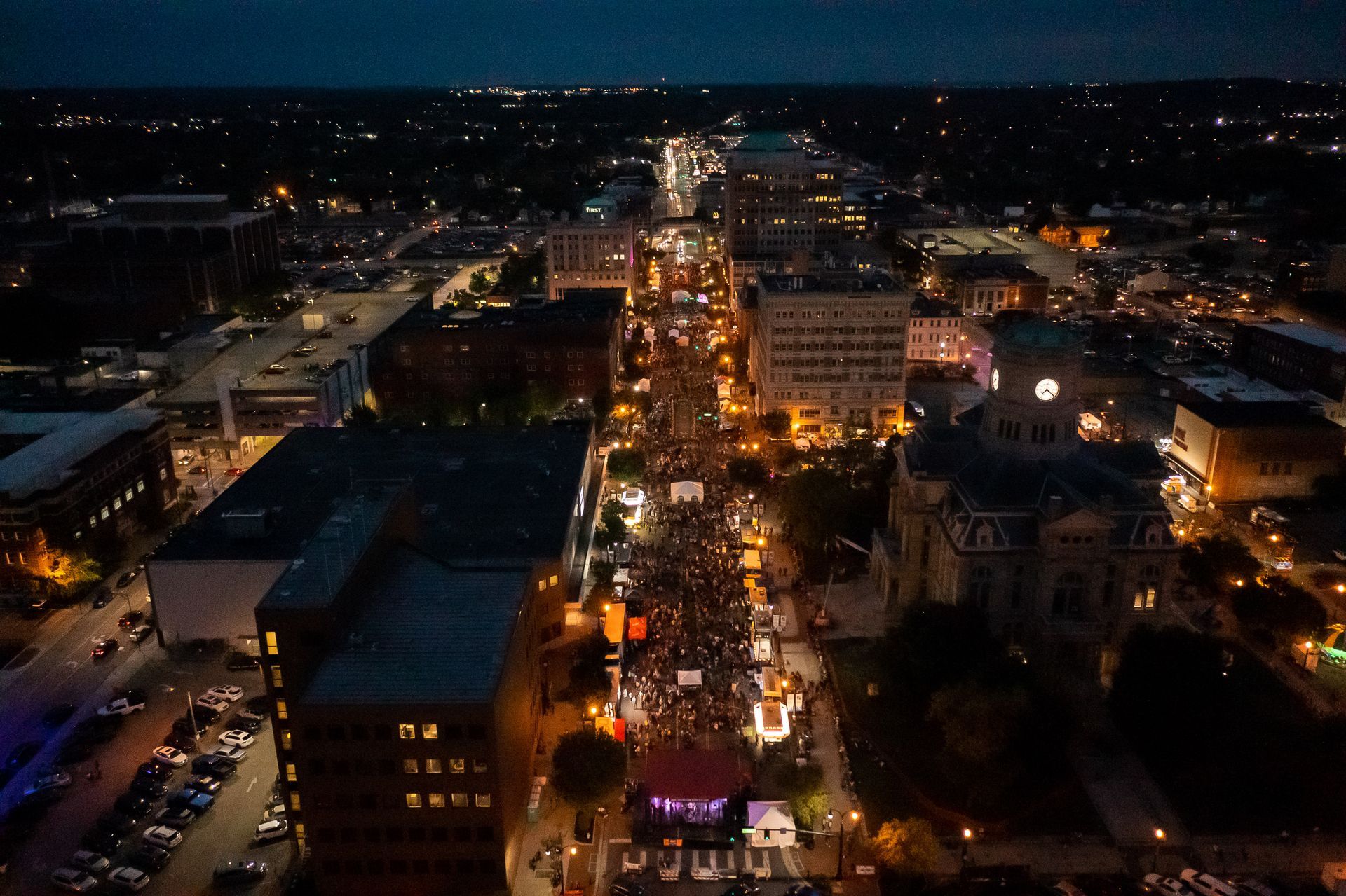 an aerial view of a city at night with lots of lights