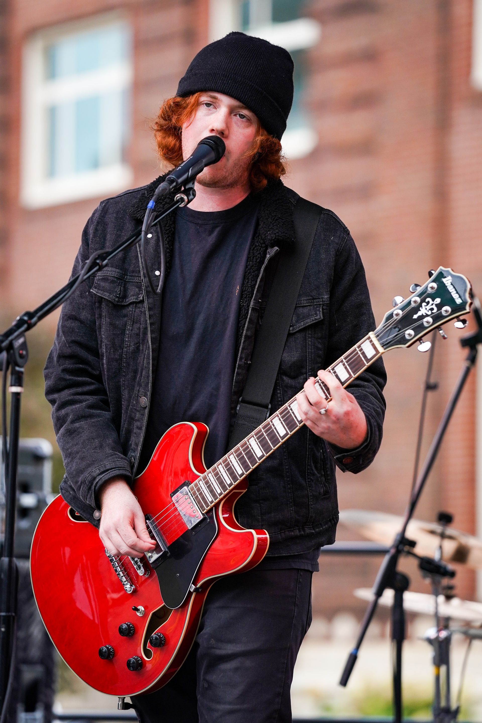 man singing and playing a guitar