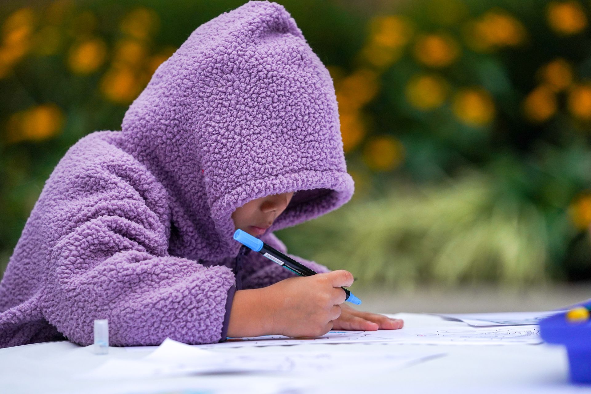 a kid in purple hoodie