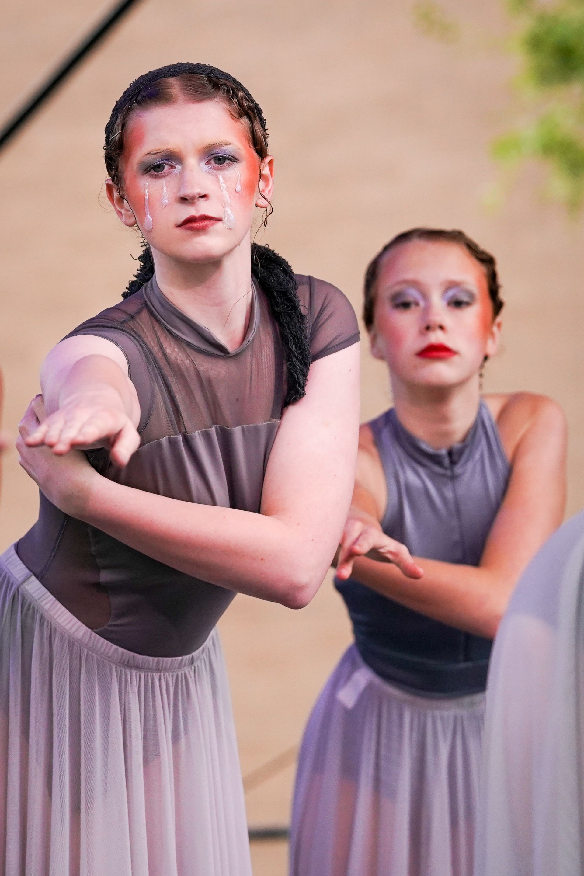 two young women are dancing together on a stage 