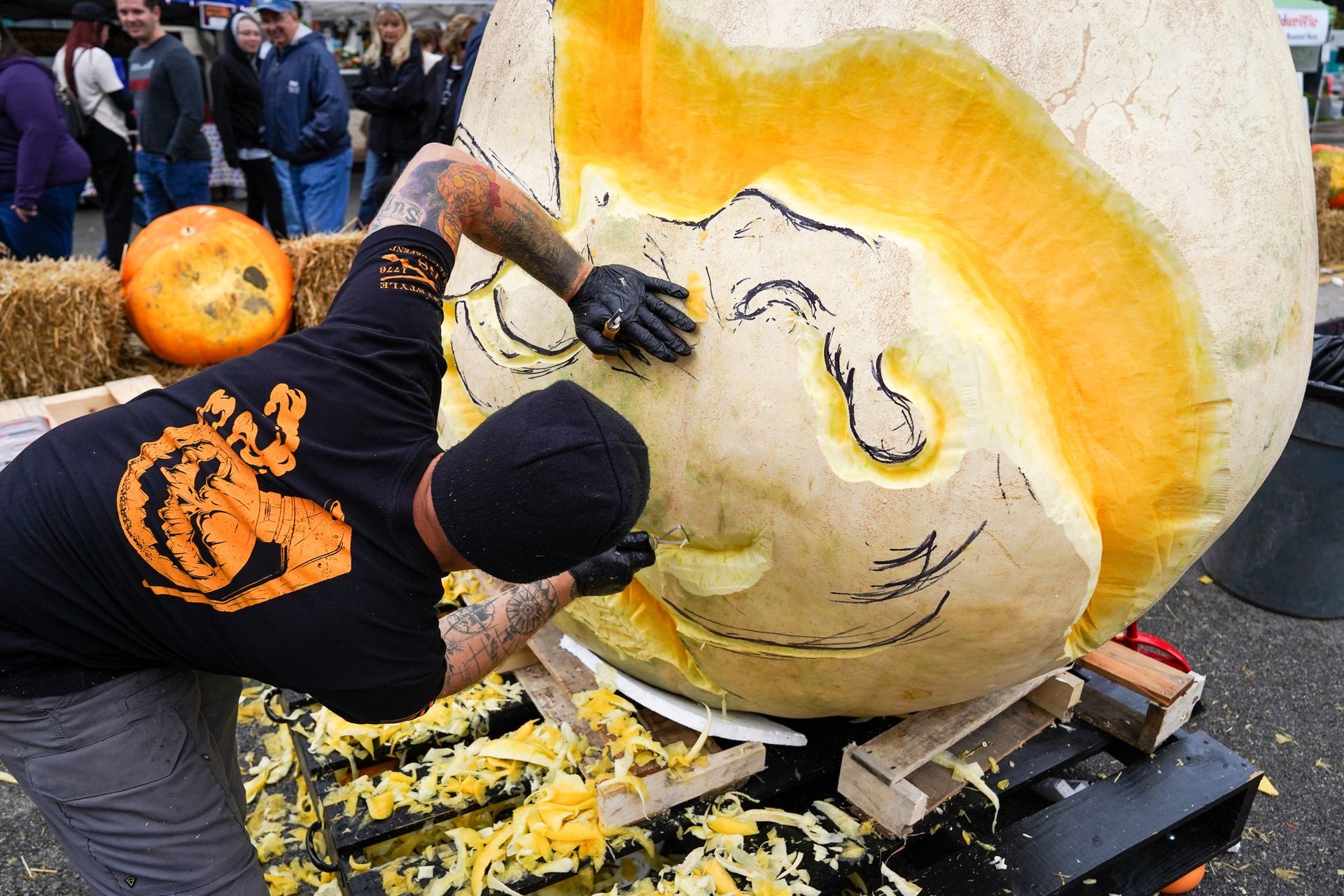 a man is carving a face out of a pumpkin