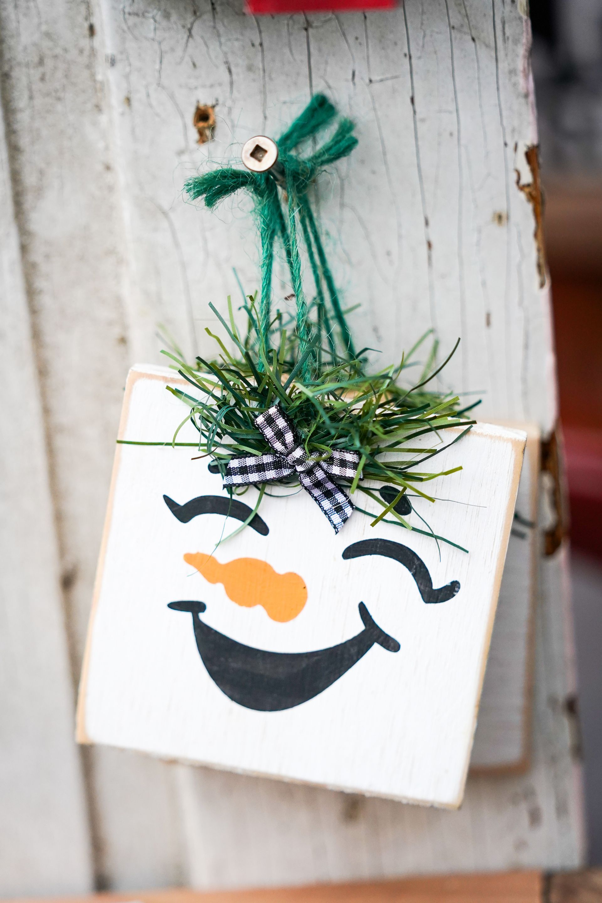 a christmas ornament with a snowman face on it